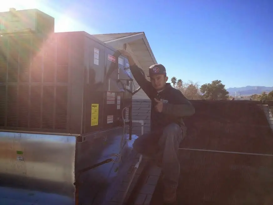 HVAC technician performing Boiler Repair on a rooftop unit in Wayne